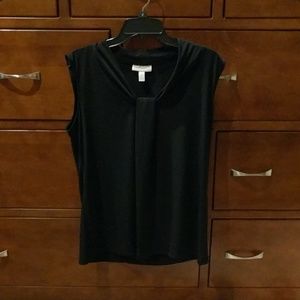 Tags still on black blouse